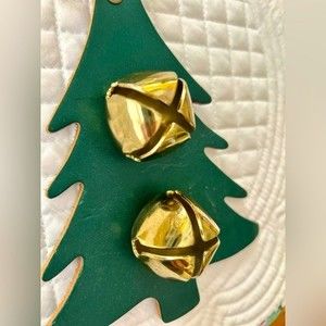 Brass jingle bells on green leather tree-shape.